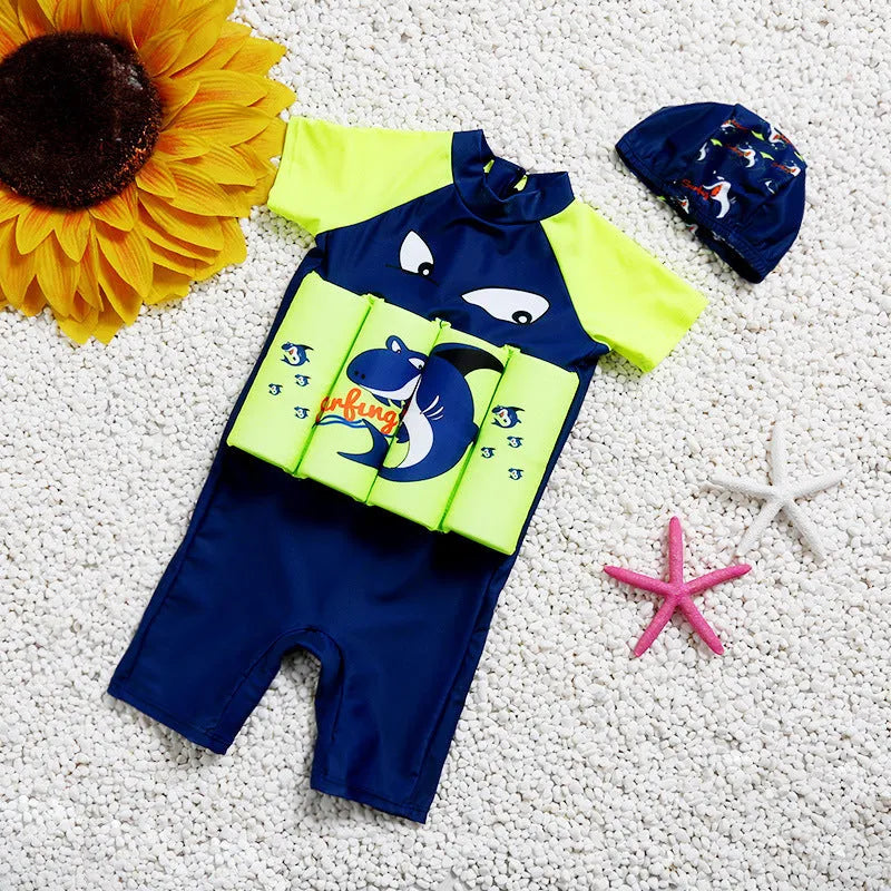 Child wearing a cartoon print buoyancy swimsuit in a swimming pool.
