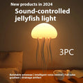 Jellyfish mood lamp with glowing adjustable tentacles on a desk next to a phone.