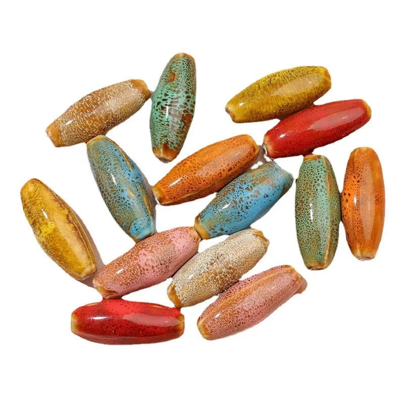 Assorted high-temperature fired ceramic bullet beads in pink, yellow, blue, red, coffee, green, orange, and mixed glaze colours.