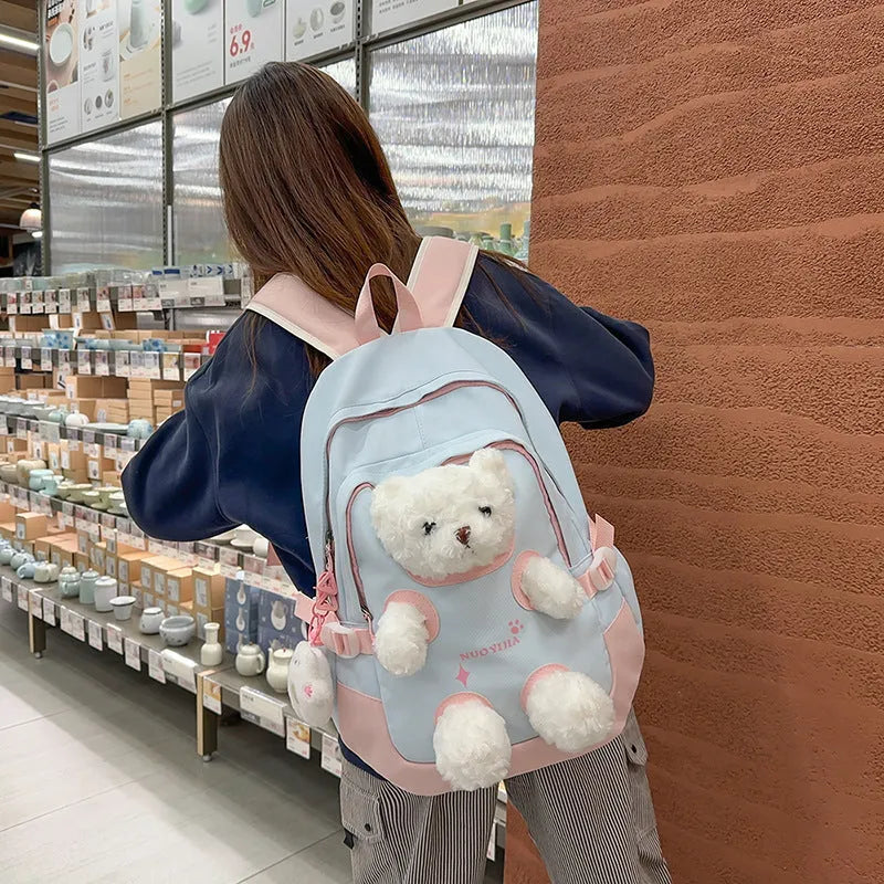 Nylon school backpack in macaron colours with curved shoulder straps and literary style design.