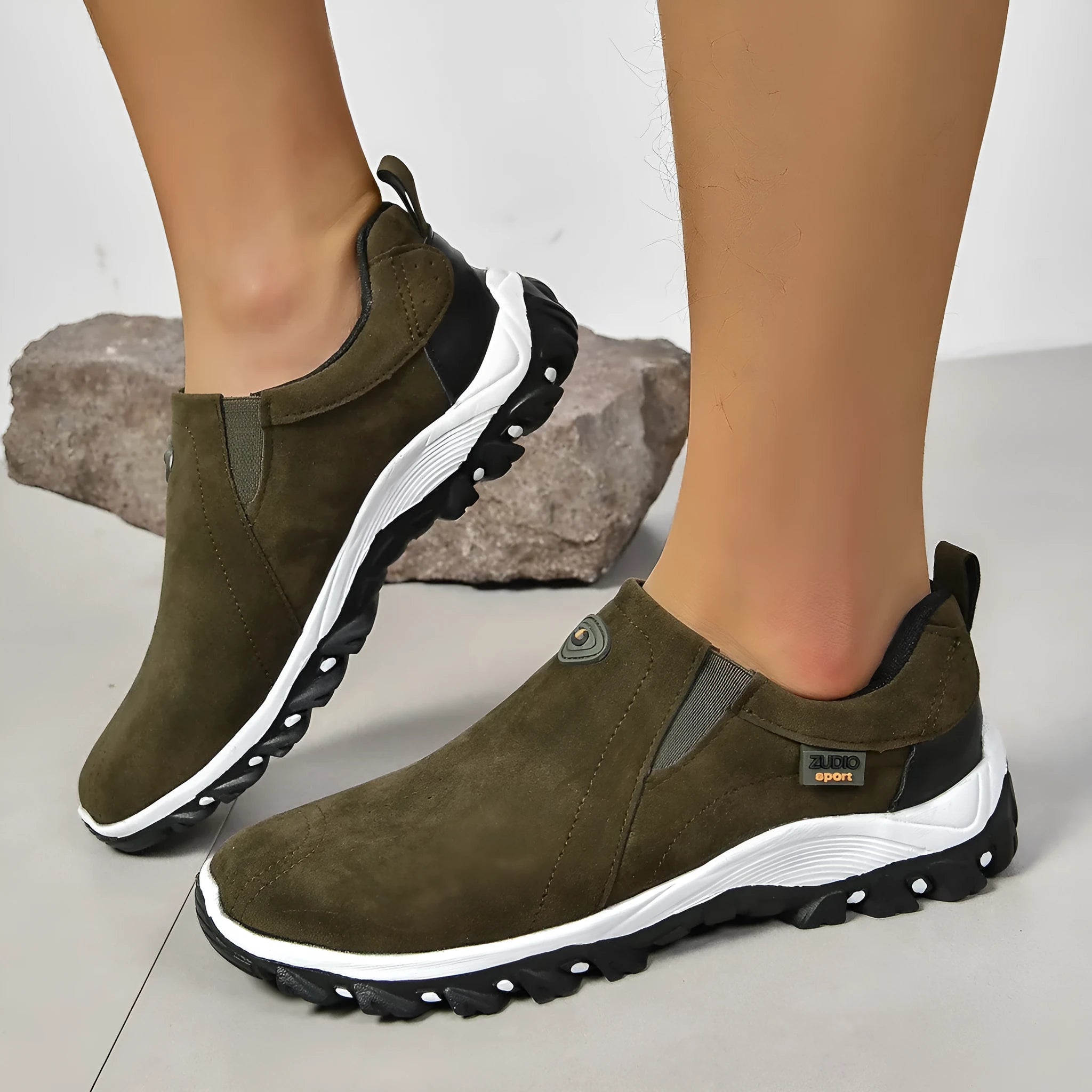 A pair of grey round-toe men's slip-on shoe covers made of PU with a rubber sole.