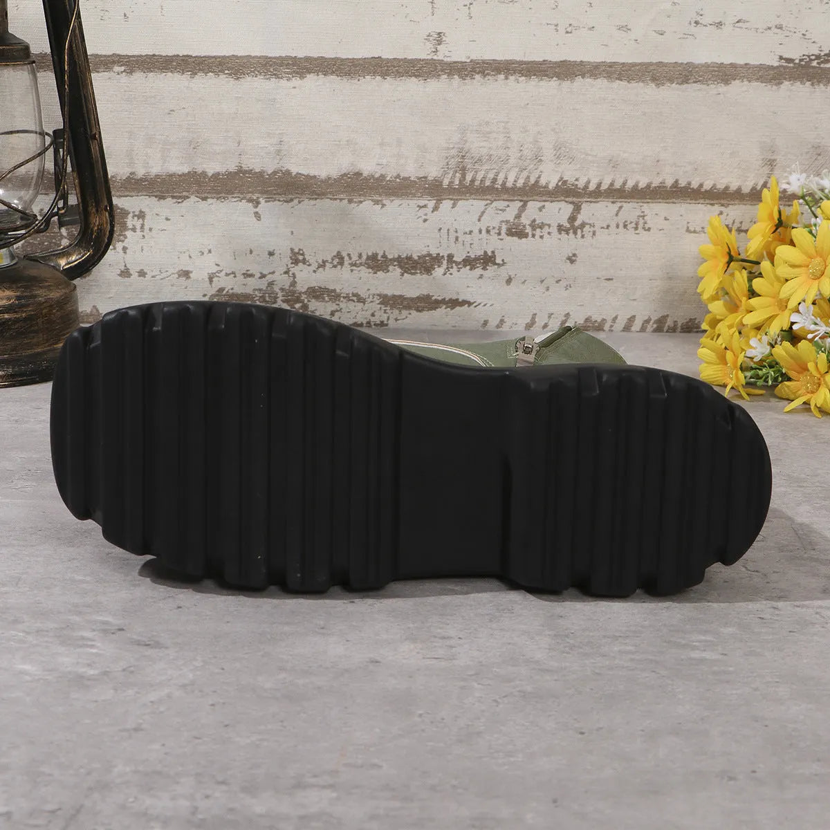 Women's black retro platform Martin boots with patchwork detail and side zipper.