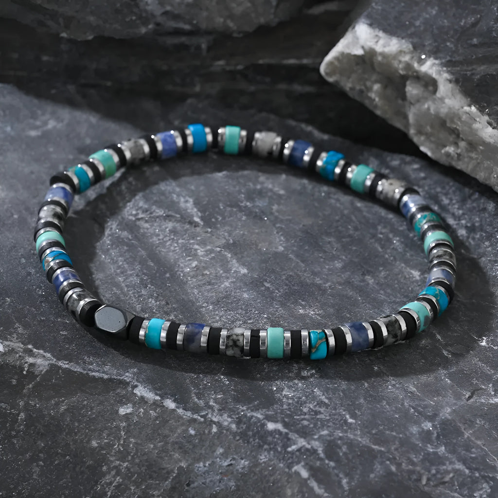 Bohemian bracelet with cylindrical semi-precious stone beads in a hand-woven geometric design.