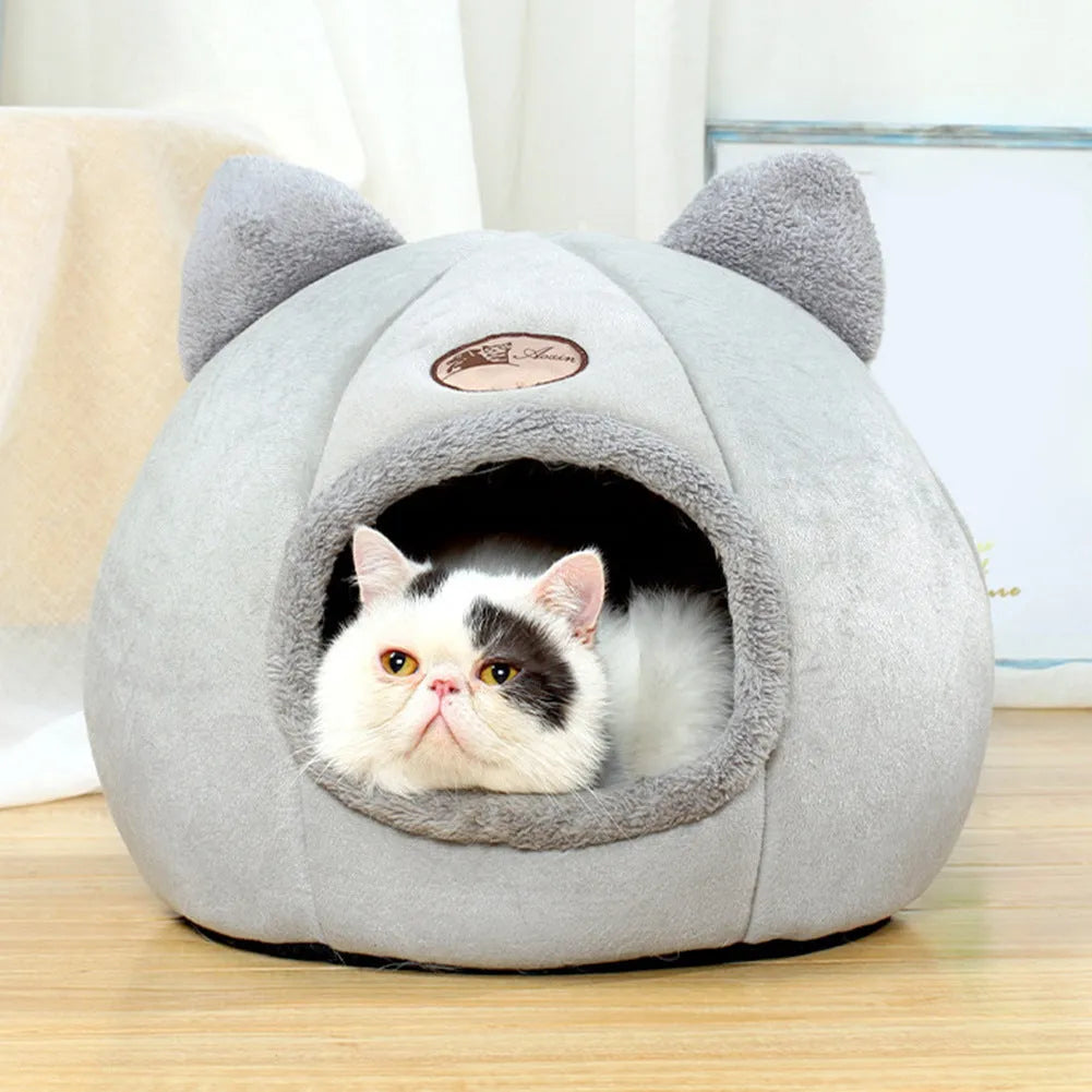 Grey enclosed cat sofa bed with a round entrance hole, showing a soft plush interior and removable cushion.