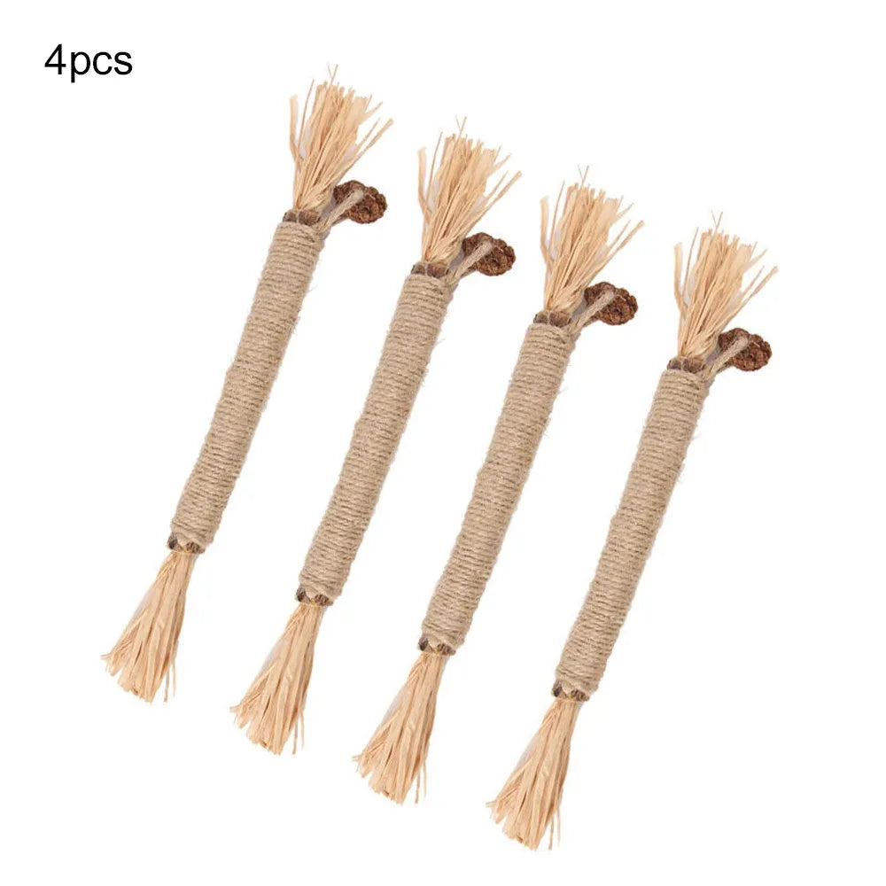Three natural silvervine chew sticks for cats on a wooden surface.