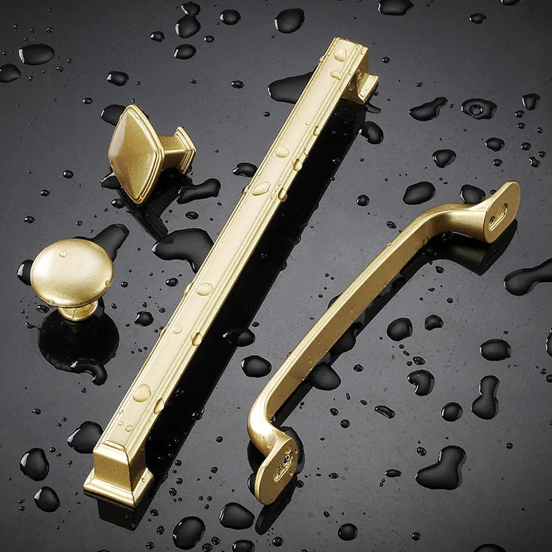 Gold-coloured aluminium alloy single hole cabinet handle with a modern T-shape design.