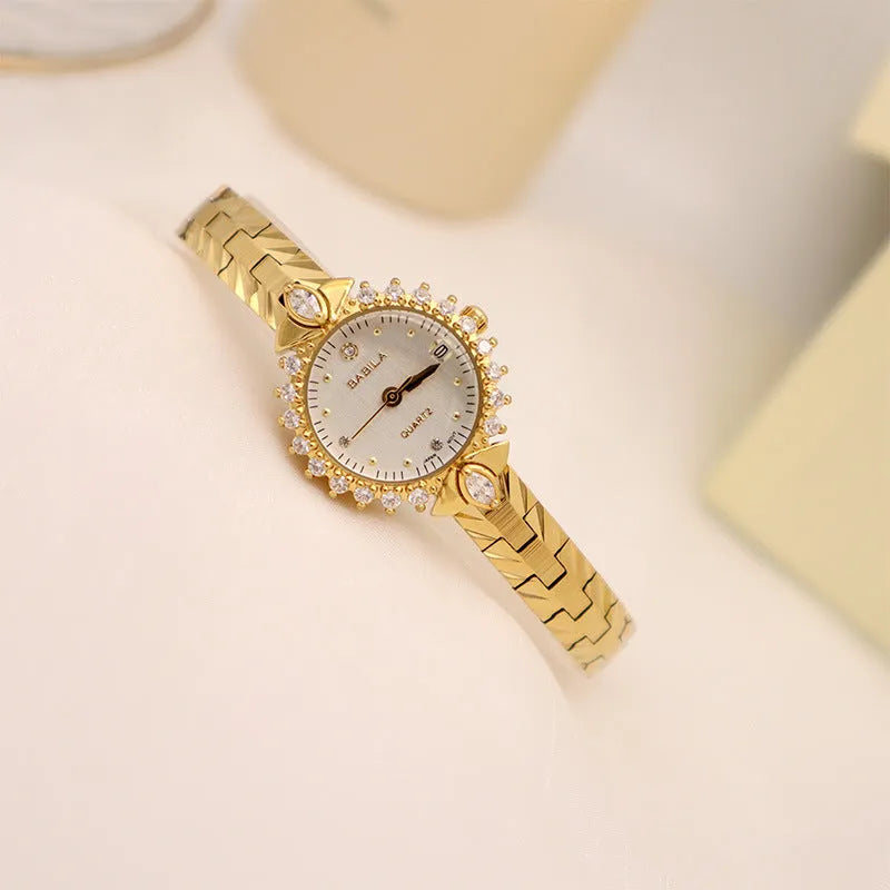 Women's gold vintage style quartz watch with diamond embossed bracelet.