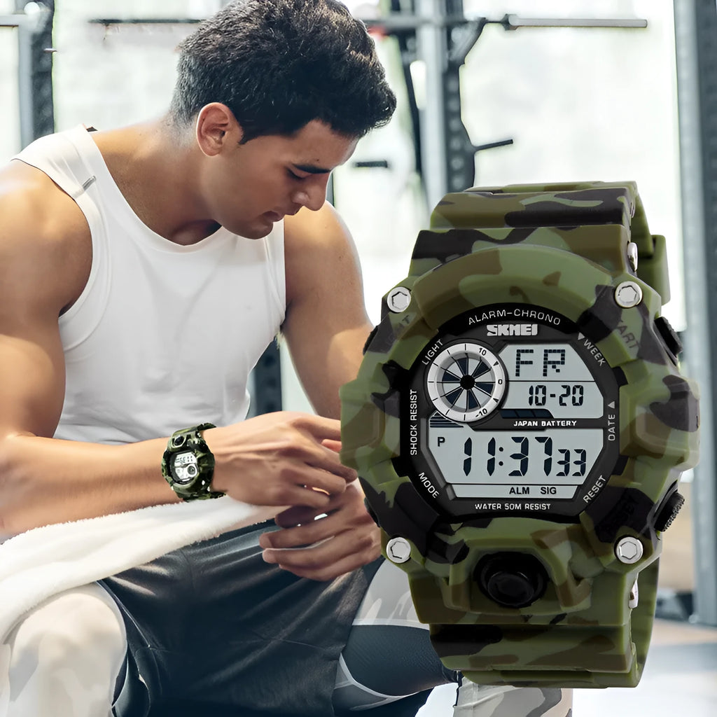 Camouflage green waterproof electronic sports watch with round dial and plastic strap on wrist.