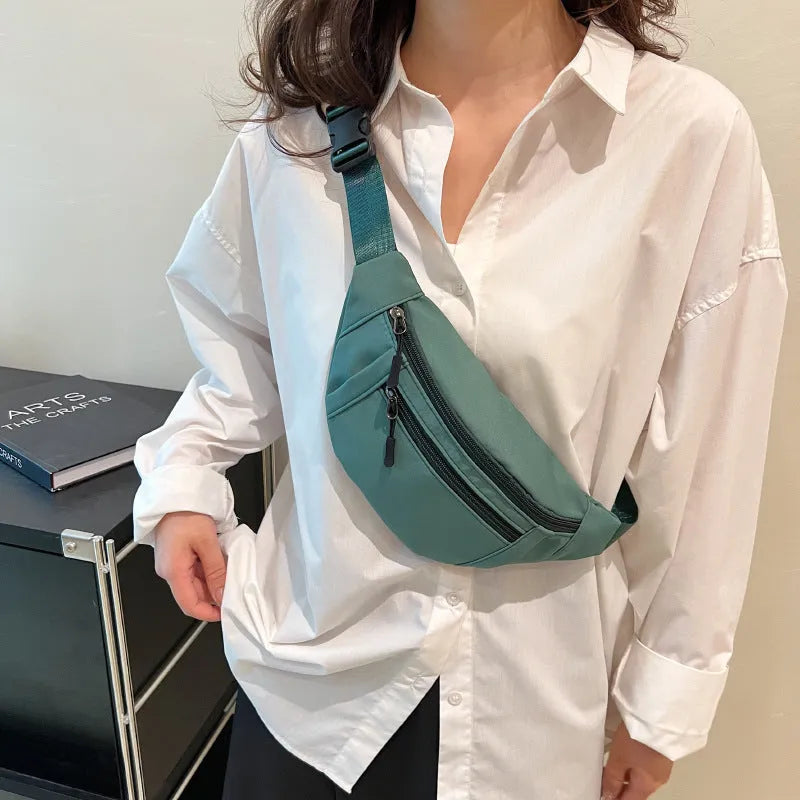 Soft nylon multi-layer mobile phone waist bag with crossbody strap, three-dimensional pocket, and sewing thread detail.