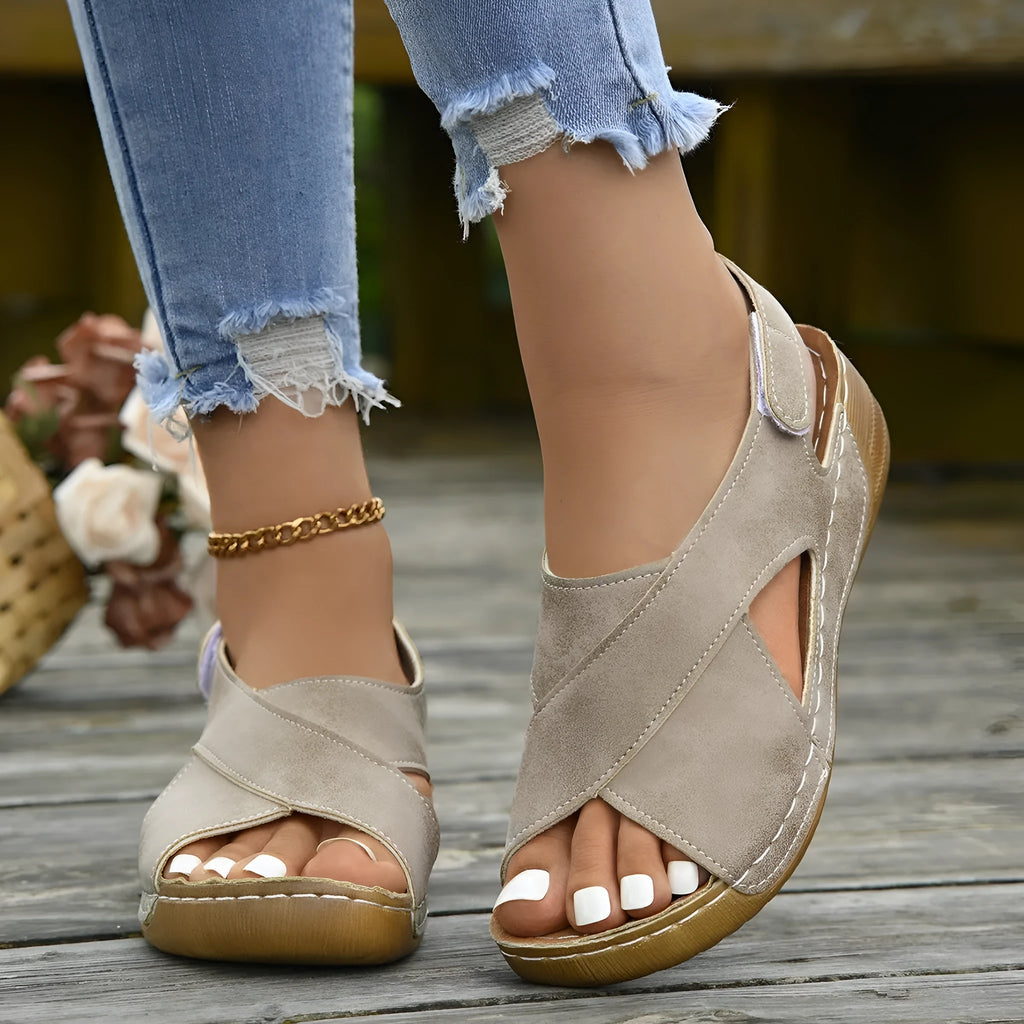 Women's brown Roman platform sandals with a skirt detail and velcro strap on a 1cm rubber sole.