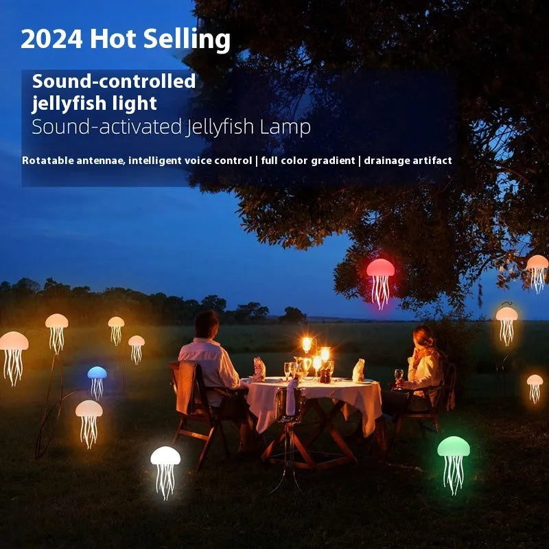 Jellyfish mood lamp with glowing adjustable tentacles on a desk next to a phone.