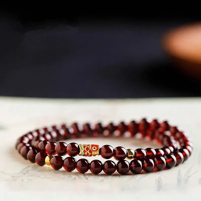 Wine red garnet coloured glass bead bracelet in New Chinese style, shown in single and double circle options.