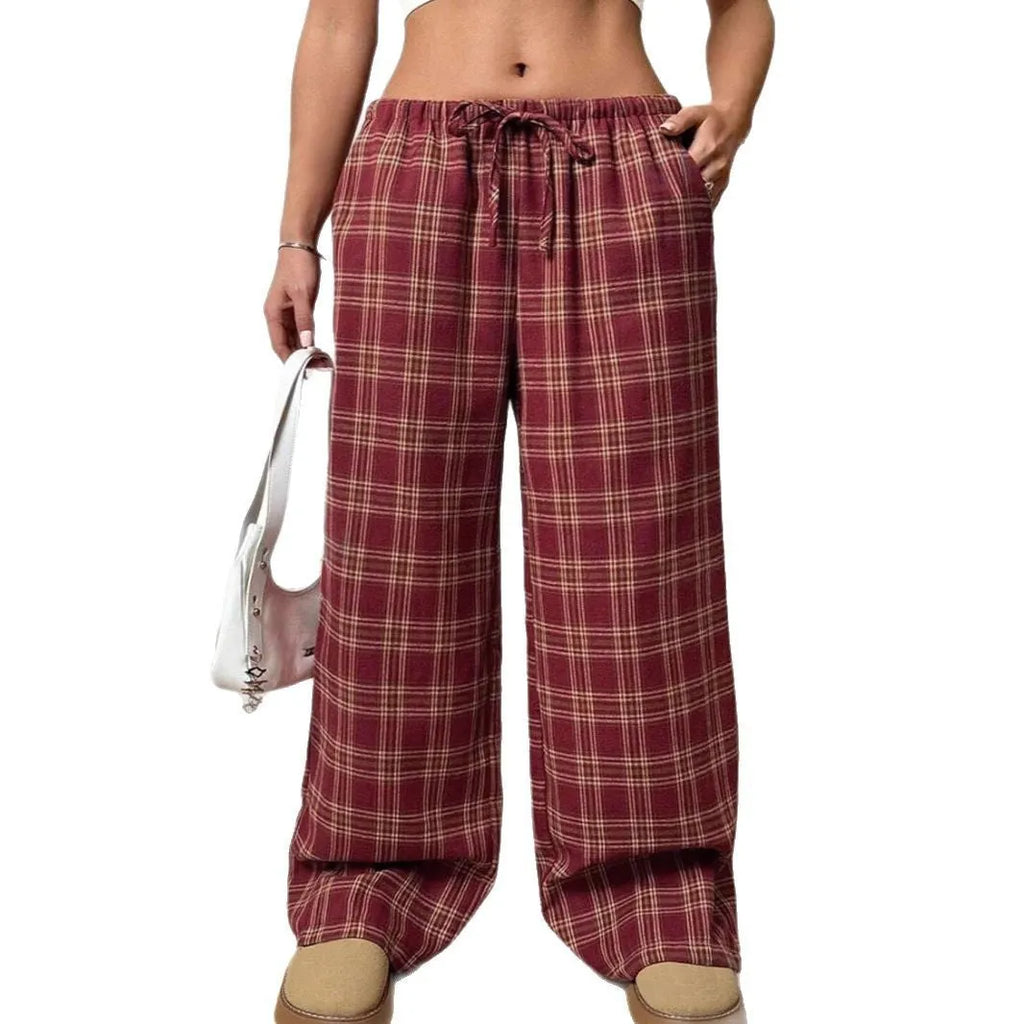 Blue women's loose fit casual trousers with a drawstring waist and front pockets on a hanger.