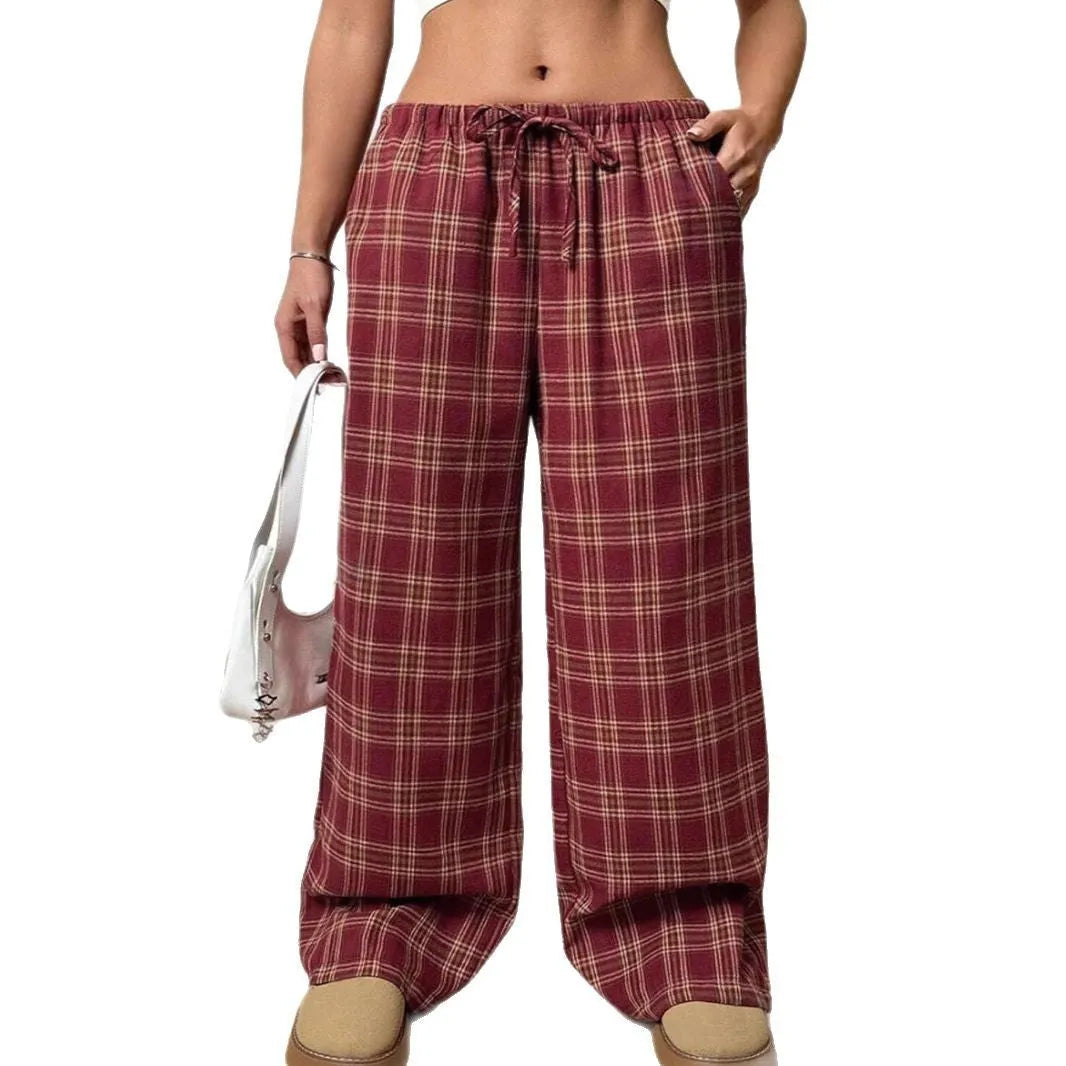 Blue women's loose fit casual trousers with a drawstring waist and front pockets on a hanger.