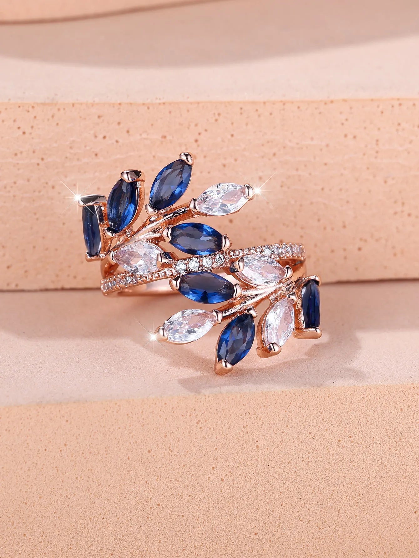 Adjustable copper leaf-shaped ring with a central horse eye zircon stone, shown in a rose gold finish.