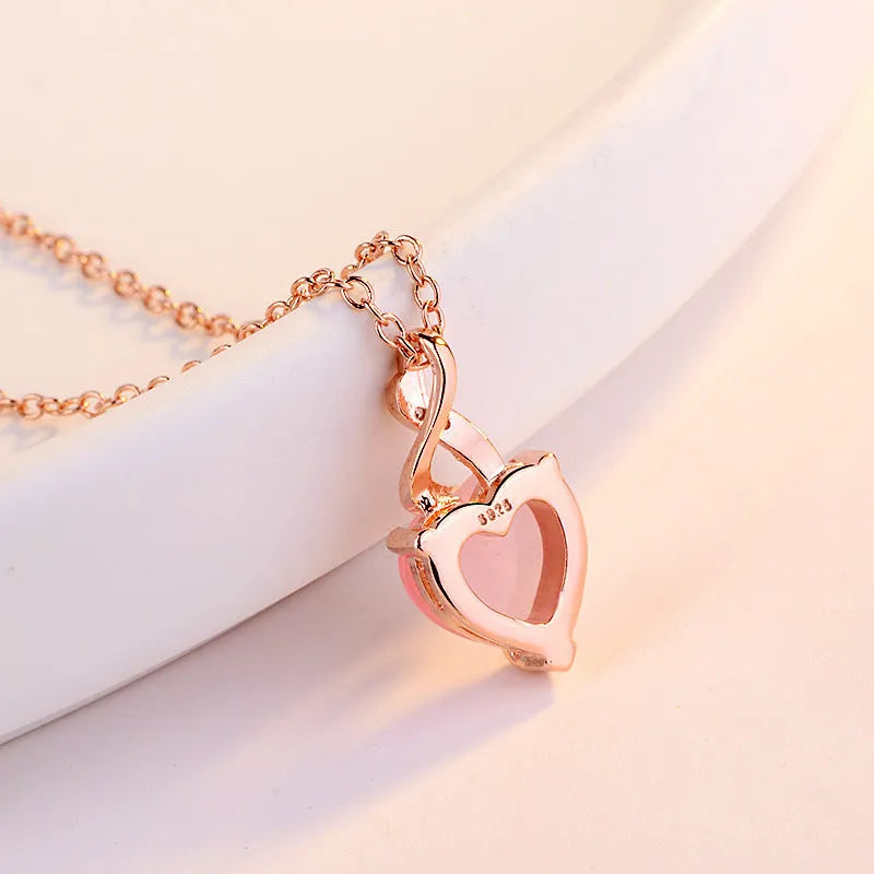 Heart-shaped pink crystal pendant necklace with rose gold cross chain for women