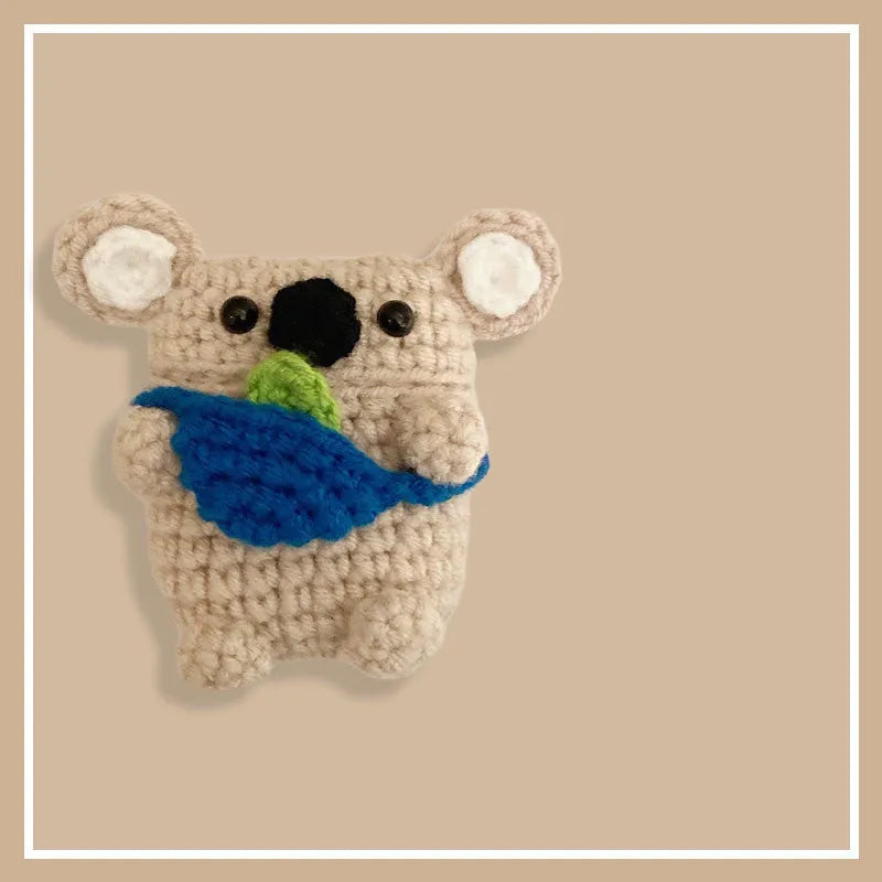 Hand-knitted grey koala bear design cover on a white Airpods case.