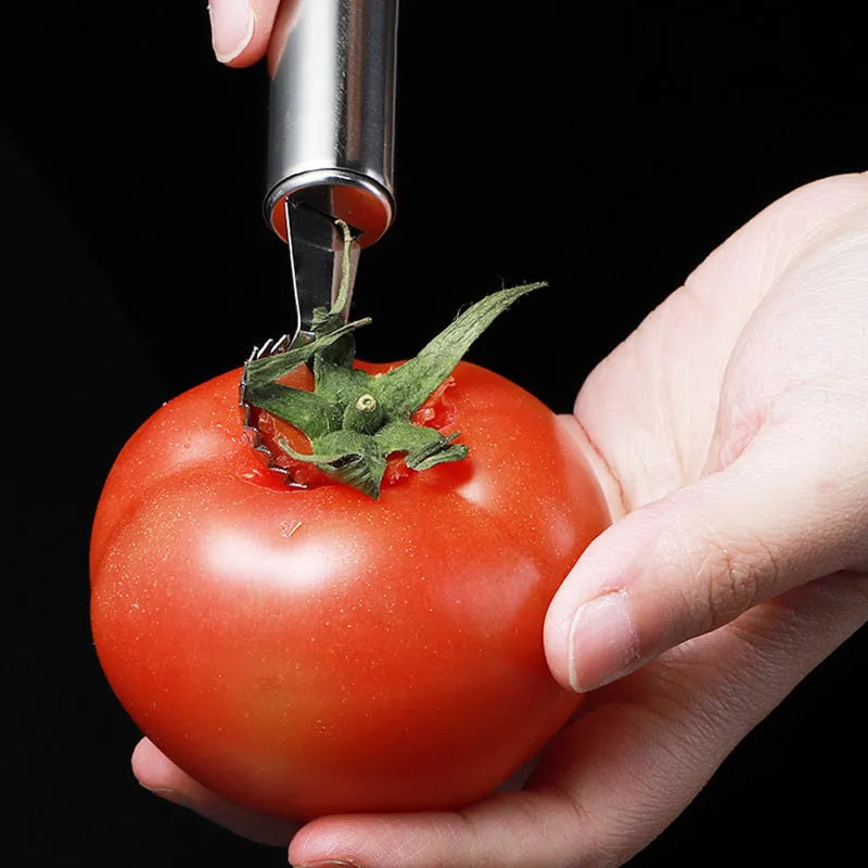 Stainless steel strawberry stem remover on a kitchen counter, modern minimalist design for coring fruit