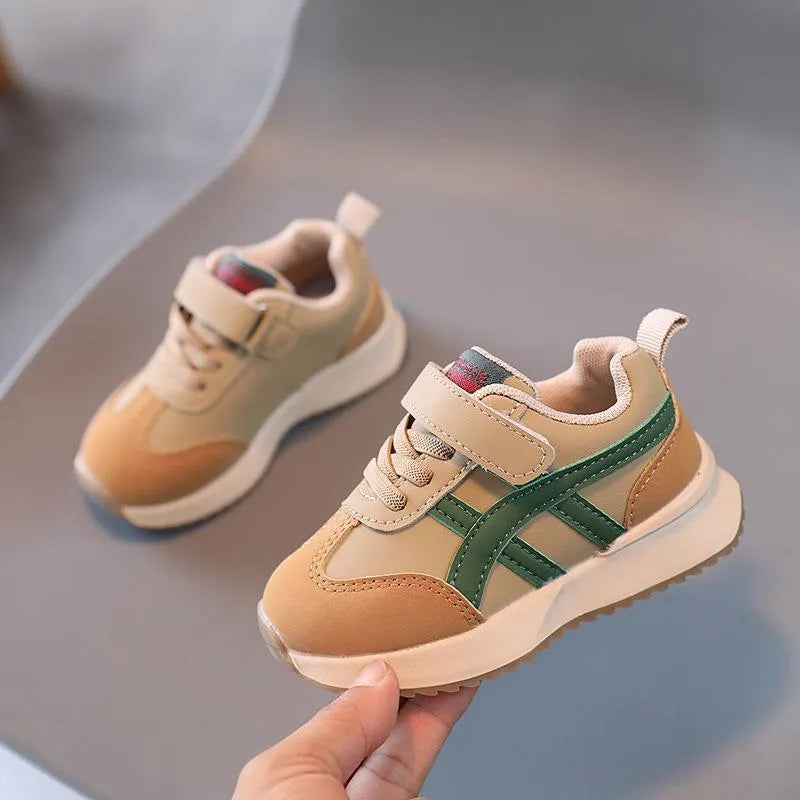 Children's white casual sneaker with Velcro strap, synthetic leather upper, and rubber sole on a neutral background.