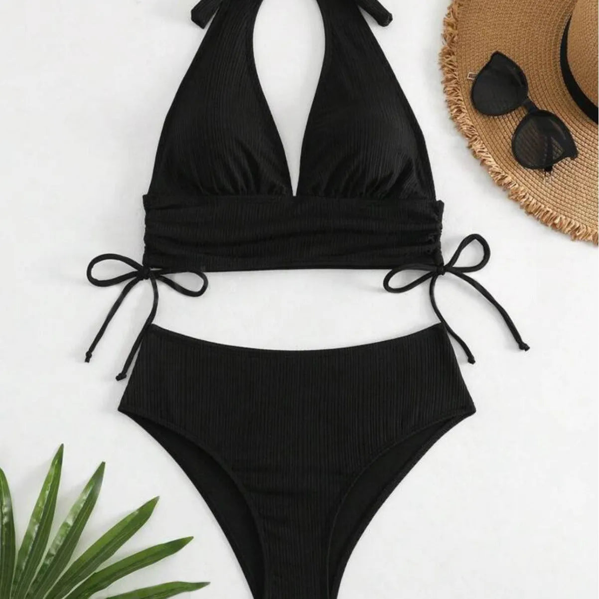 Black and pink women's lace-up halter bikini set with briefs, made from polyester fabric.