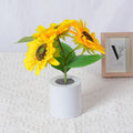 Rechargeable artificial sunflower LED night light on table with USB cable