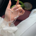 Women's white imitation pearl necklace with sweet bow design and geometric shapes on adjustable chain