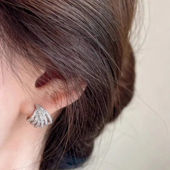 Geometric platinum-coloured zircon earrings for women on a white background.