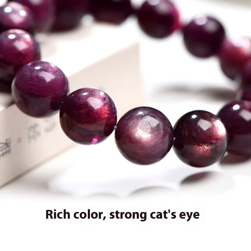 Purple lepidolite crystal round beads bracelet on a wrist, showing polished gemstone beads.