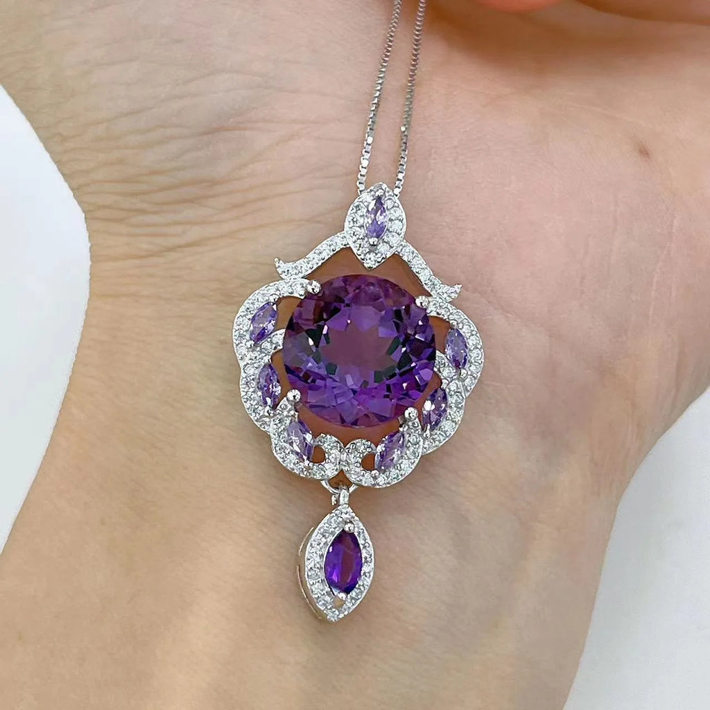 Close-up of a purple amethyst gemstone set in a U-shaped platinum-plated S925 silver pendant with meteor shower detailing.