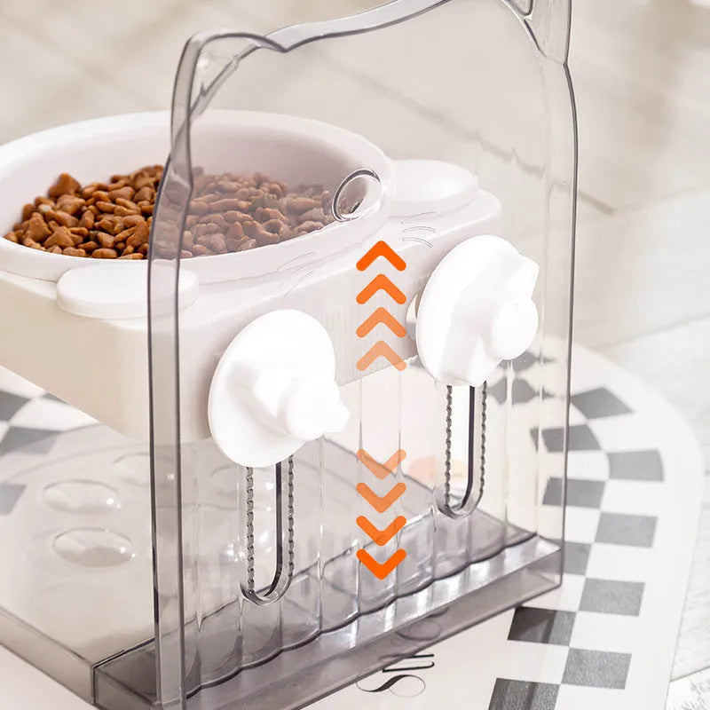 Grey adjustable height cat feeding bowl with anti-spill neck protection hanging on cage bars.