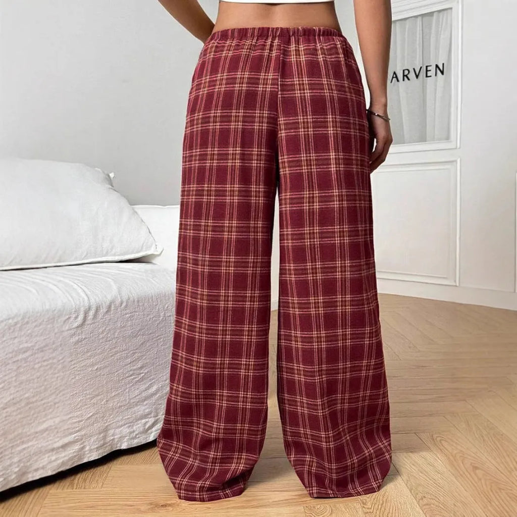 Blue women's loose fit casual trousers with a drawstring waist and front pockets on a hanger.