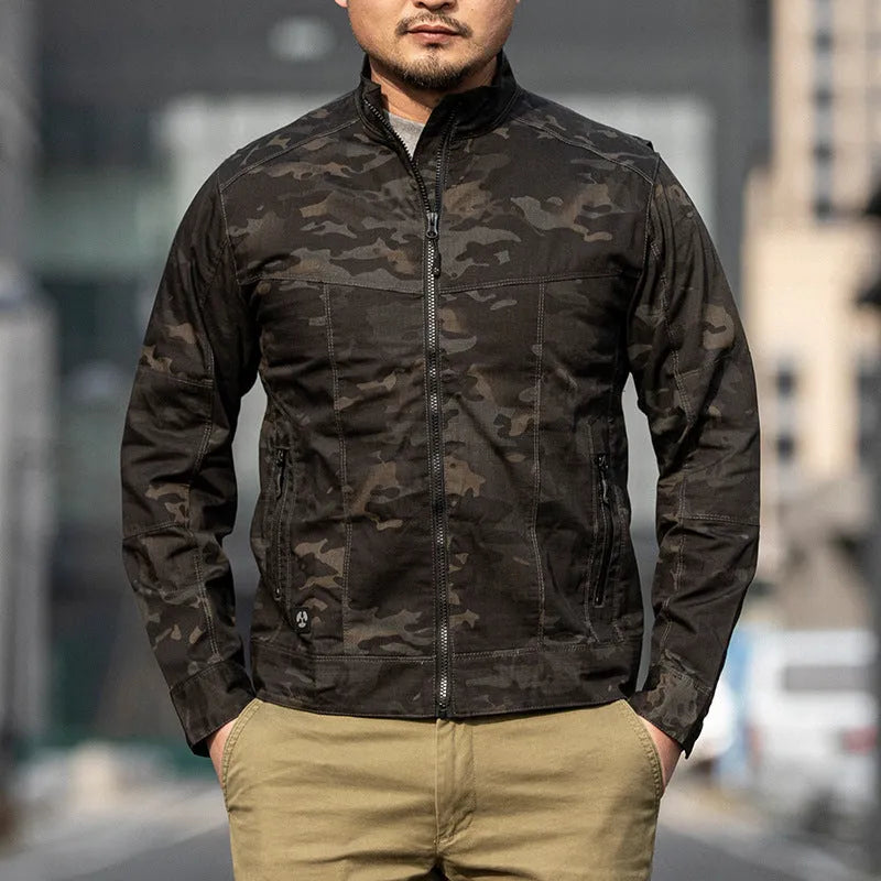 Man wearing a brown plaid outdoor tactics assassin jacket with a camouflage pattern option visible.