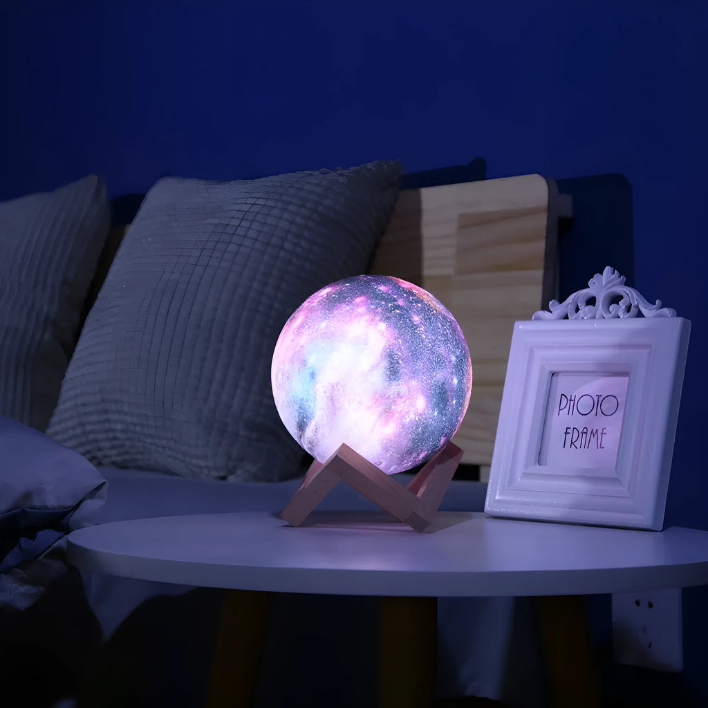 3D-printed spherical lunar night light on a surface, showing its colour-changing LED glow and remote control.