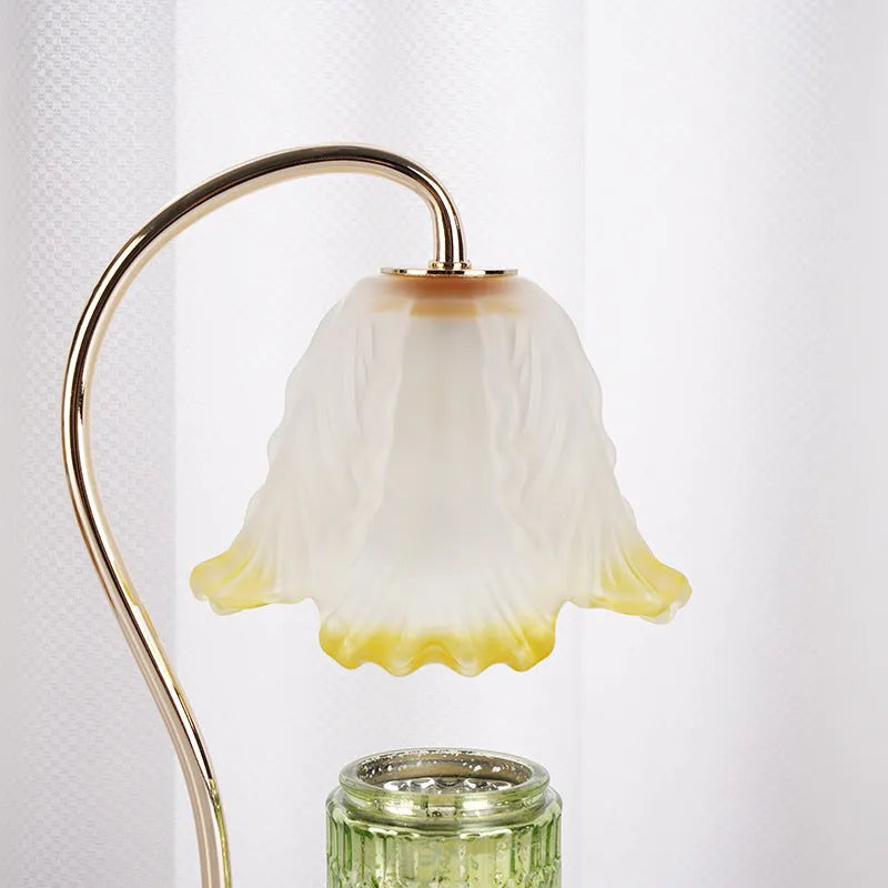 Candle light log aromatherapy table lamp with glass lampshade on nightstand, two bulbs lit, natural wood base