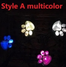 Black solar-powered animal paw print LED garden lights with four paw shapes connected to central solar pole