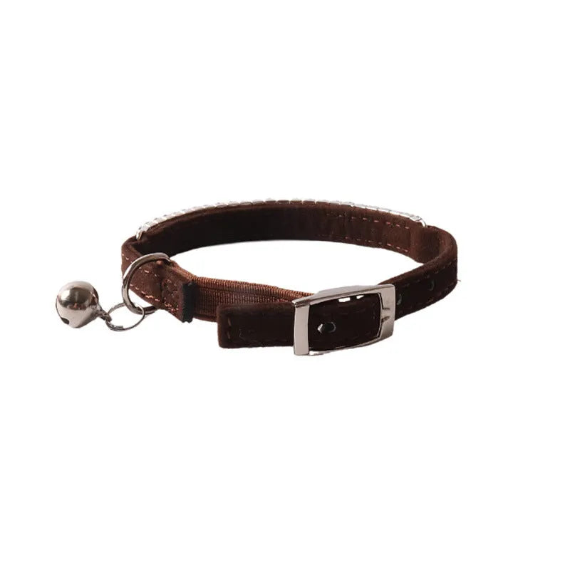 Pink cat collar with silver gang drill studs on soft flocking fabric, showing adjustable buckle and D-ring.