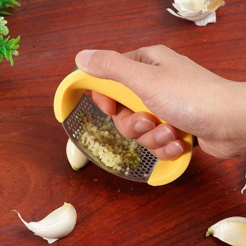 Stainless steel manual garlic press with ergonomic handle in assorted colours