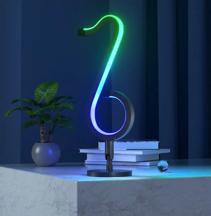 Black smart APP-controlled LED atmosphere light with 180-degree rotation on a desktop.