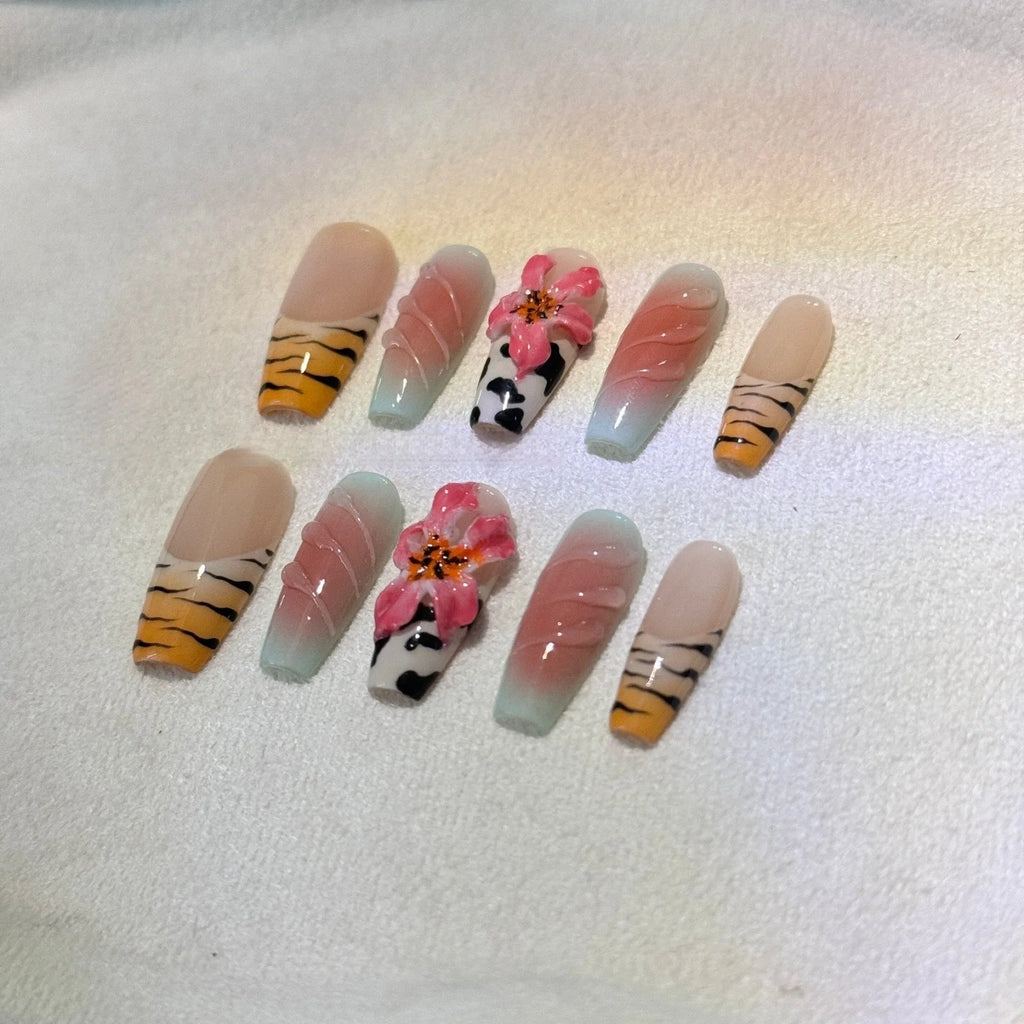 Set of false nails with hand-carved zebra pattern and lily design, showing sizes XS S M L and leopard print styles.