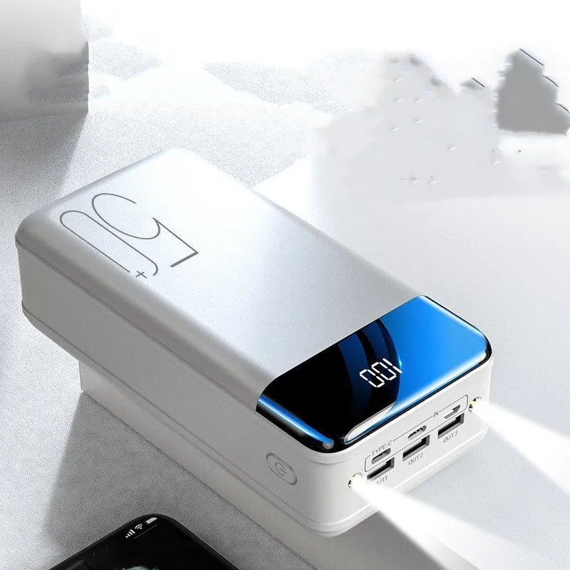 Black and white 50000mAh power bank showing three USB output ports and its large form factor.