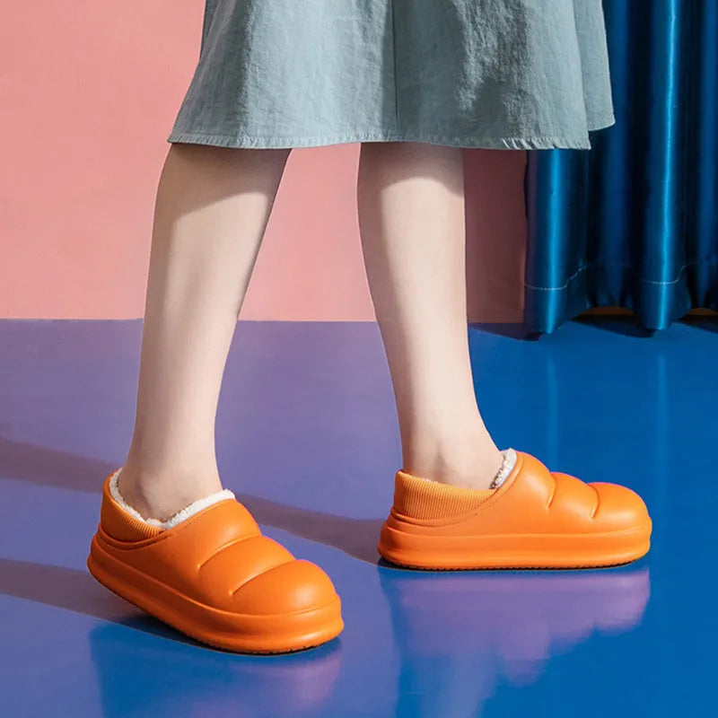 Green waterproof EVA cotton slipper with plush lining, flat sole, and hollow slip-on design.
