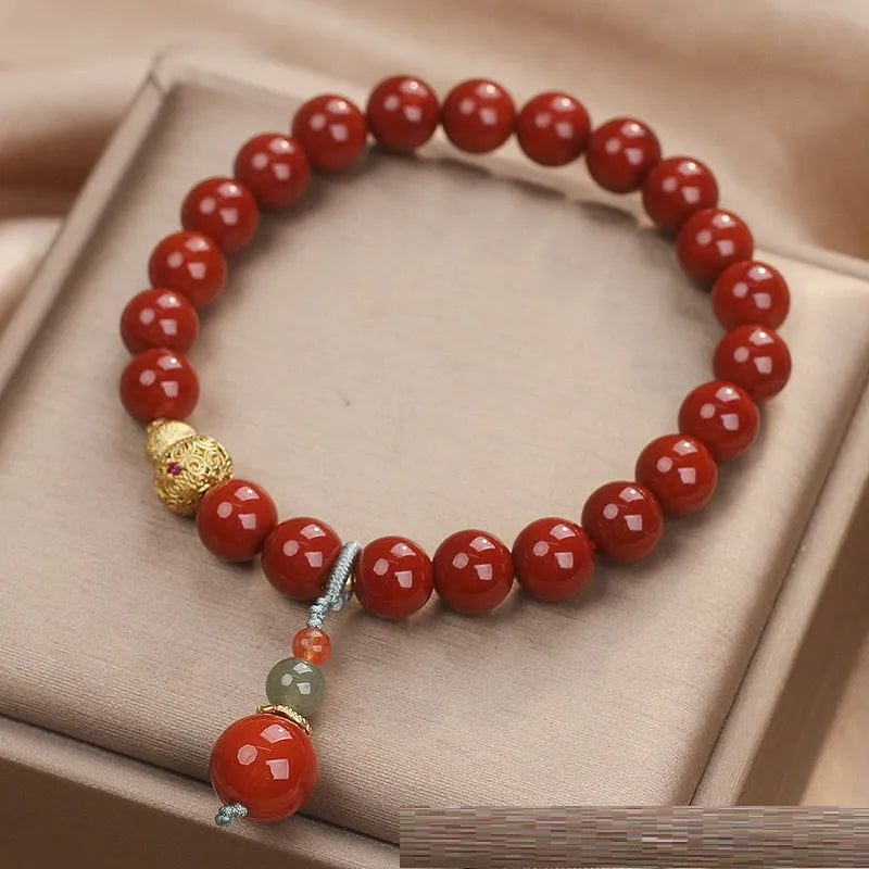 Red agate ethnic style bracelet for women on a plain background