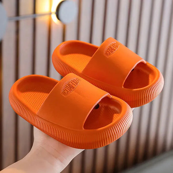 Children's mixed colour EVA slippers with textured non-slip soles and 1.5cm thick cushioning.
