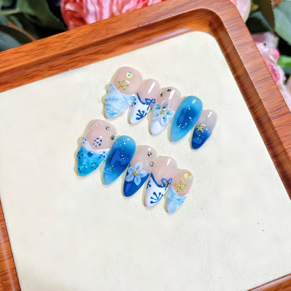 Blue hand-painted carved summer ice transparent plastic fake nails showing size range XS to L