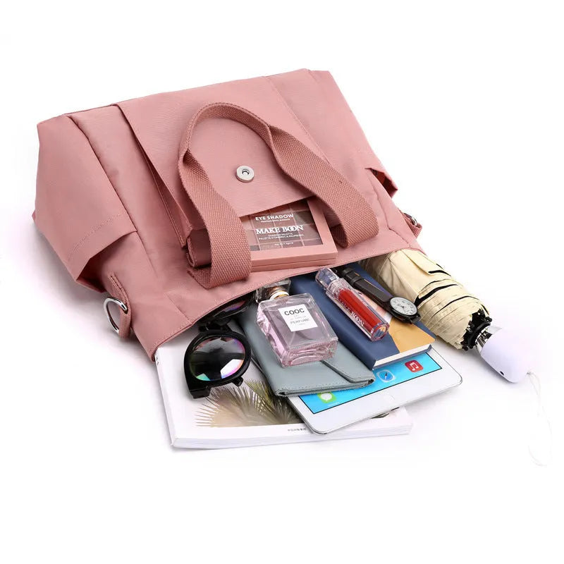 Nylon multi-interlayer shoulder bag in black with single strap and outer sandwich pocket, horizontal square shape