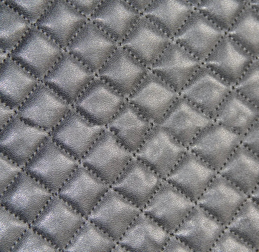 Black quilted automotive seat cover made from PU and polyester fabric, shown with plastic fitting hooks.