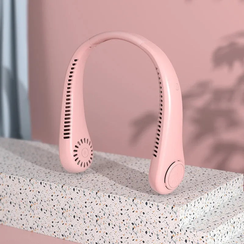 Blue bladeless neck fan hanging around a person's neck, showing the air outlet and USB charging port.