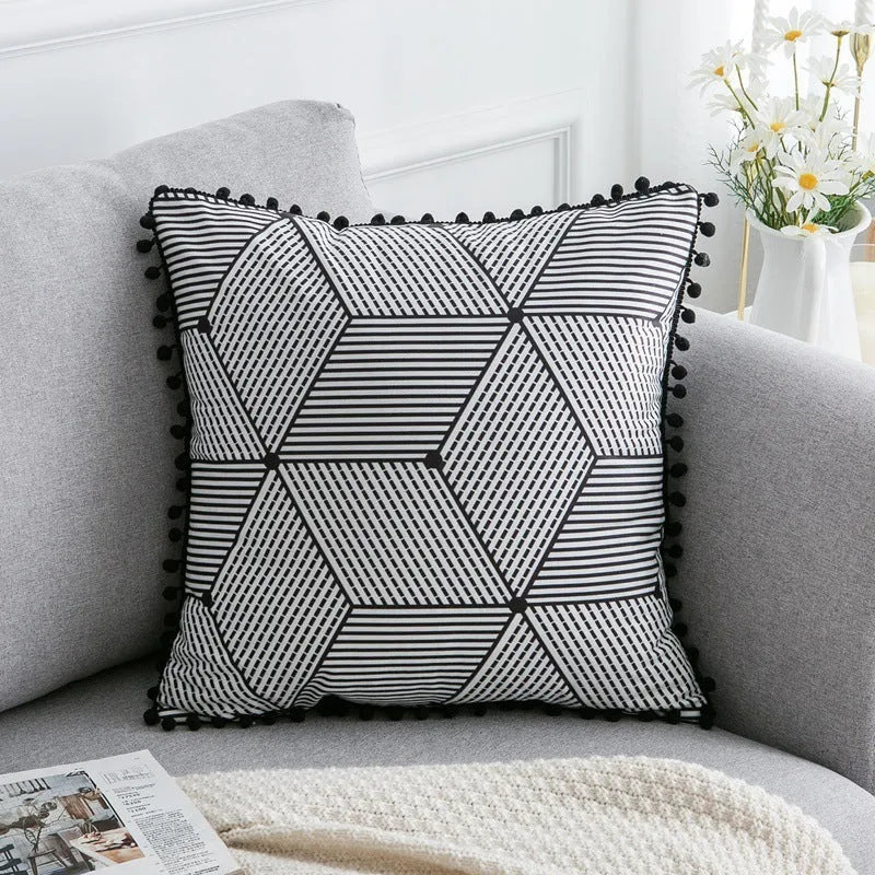 Bohemian national style polyester cushion cover in light grey on a sofa.