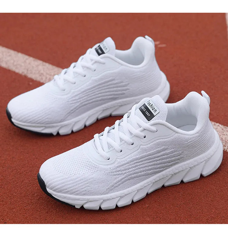 Women's low-top black and white casual running sneakers with MD sole and cross-strap detail.