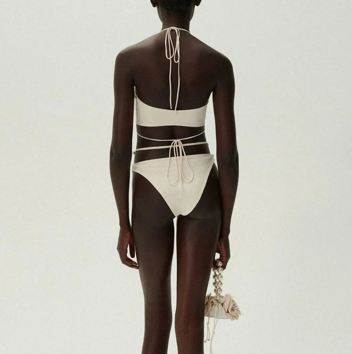 Black women's two-piece bikini swimsuit with lace-up front detail on the top.